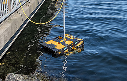yellow underwater robotic vessel near a pier